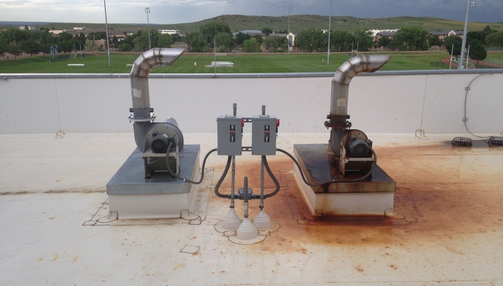 Natatorium exhaust fans on roof, rust and corrosion is destroying the chemical storage room fan.
